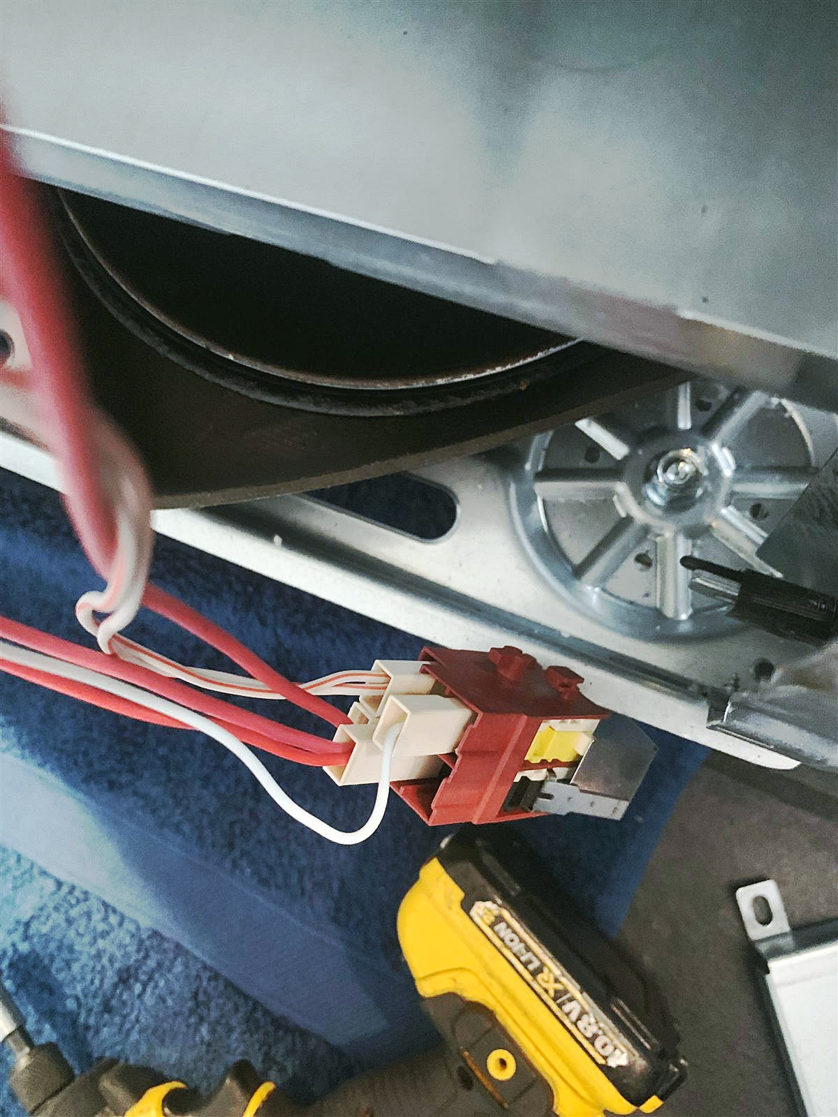 Washing machine door lock wiring being tested